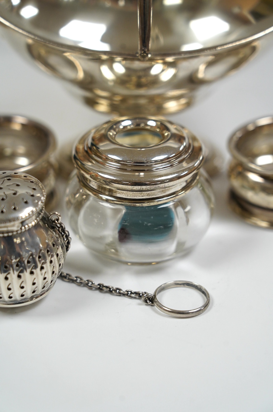 An Edwardian silver boat shaped sugar basket, by Thomas Bradbury & Sons, London, 1905, 13.9cm, together with two silver napkin rings, mounted glass hair tidy and a sterling pomander. Condition - poor to fair